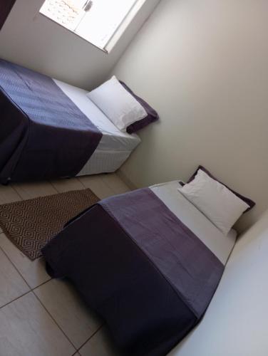 a bedroom with two beds and a window at Apartamento por temporadas in Rio Verde