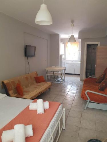 a living room with two beds and a couch at nastro azzurro sole in Kallithea Halkidikis