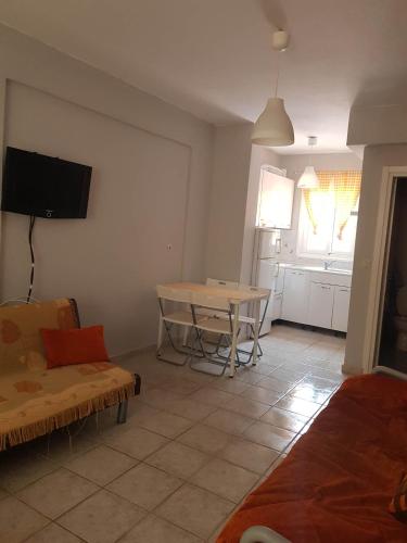 a living room with a table and a couch at nastro azzurro sole in Kallithea Halkidikis