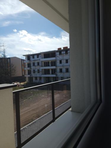 a balcony with a view of a building at Riva i Lido Srebrno jezero in Veliko Gradište