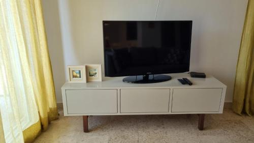 a television on a white cabinet in a room at Casa Emma in Poreč