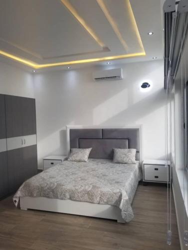 a bedroom with a bed in a white room at Appartement à Cotonou in Cotonou