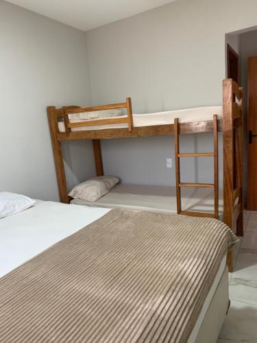 a bedroom with two bunk beds and a ladder at Casa villa Gravatá in Gravatá