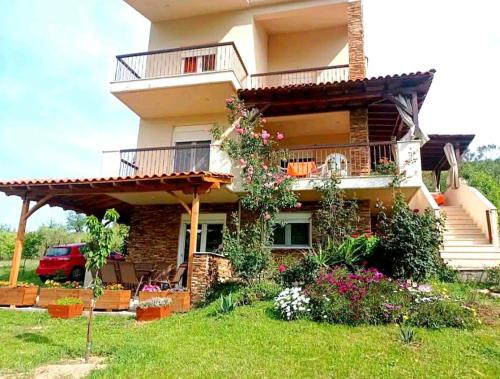 a large house with a balcony and a yard at Nouli's Mountain View Haven in Nikiti