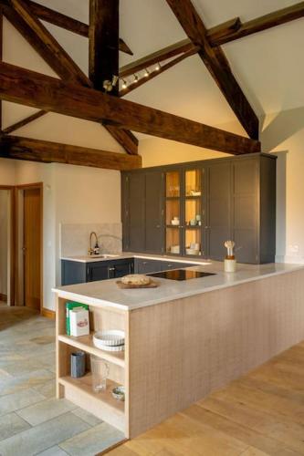 a kitchen with a island in the middle of a room at Wood Cottage in York