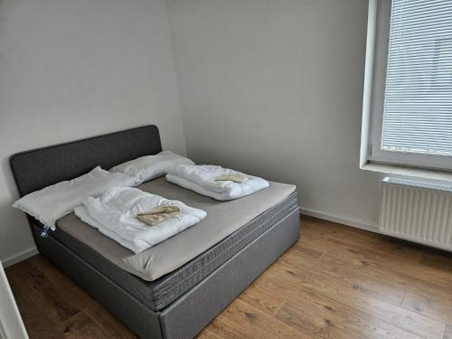 a bed with two pillows on it in a room at GardenLoft Terrace no 3 in Vienna