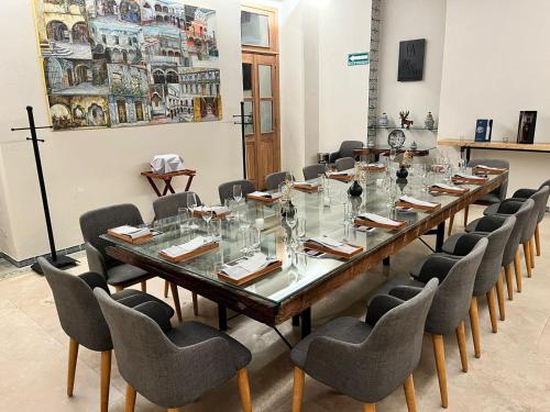 a long table in a room with chairs around it at Casa Azulai Puebla Hotel Boutique in Puebla