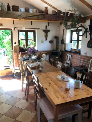 a dining room with a wooden table and chairs at Pension Laura in Chřibská