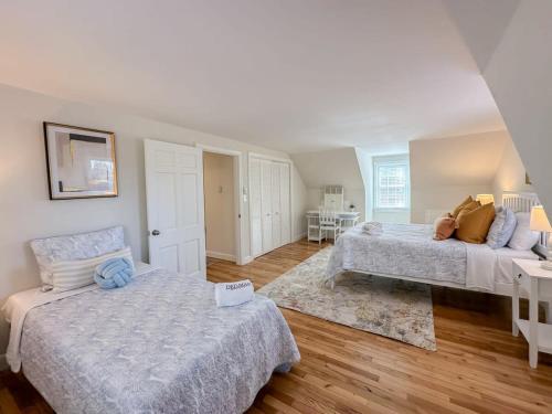 a large room with two beds and a table at 2 Miles to Nauset & Coast Guard Beach Dog Friendly in Eastham