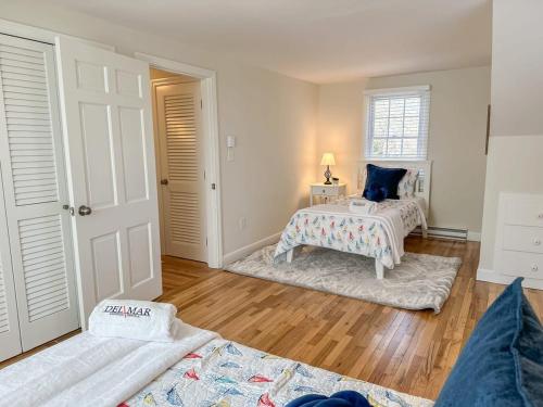 a living room with two beds and a table at 2 Miles to Nauset & Coast Guard Beach Dog Friendly in Eastham