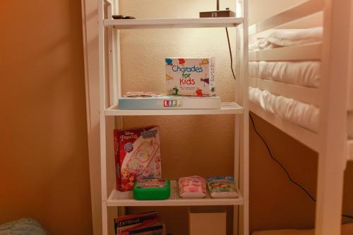 a book shelf in a childs room with snacks at Sojourn Relaxing Condo near the Beach with Pool in Virginia Beach