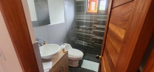 a bathroom with a white sink and a toilet at Hotel Villa Javier VDL in Villa de Leyva