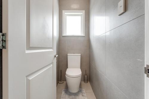 a small bathroom with a toilet and a window at Countryside Haven Retreat with Pool and Deck in Clevedon