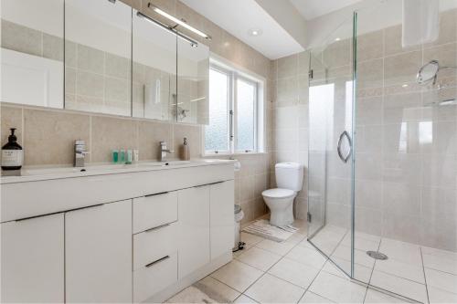 a bathroom with a sink and a shower and a toilet at Countryside Haven Retreat with Pool and Deck in Clevedon