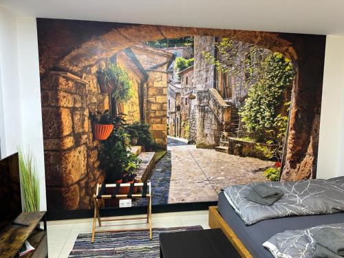 a wall mural of an alleyway in an old town at Danube Island Apartment 3 in Vienna