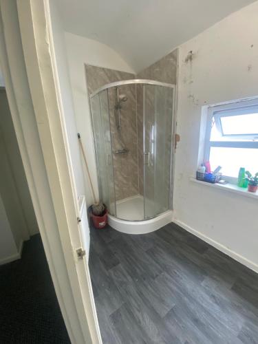 a bathroom with a shower with a glass shower stall at Single Room in Erdington B23 in Birmingham