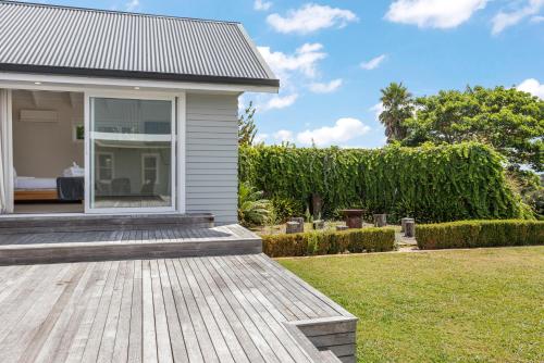 a house with a wooden deck in the yard at Countryside Haven Retreat with Pool and Deck in Clevedon