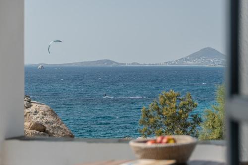 a view of the ocean with a bowl of fruit at Studios Kontos in Mikri Vigla