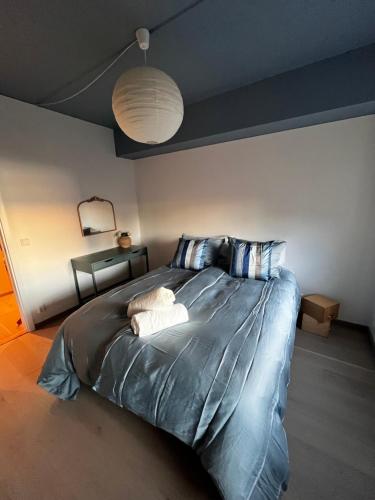 a bedroom with a large bed with two pillows at Bjørvika - Chic apartment in Oslo center in Oslo