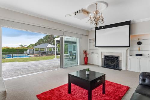a living room with a large screen on the wall at Countryside Haven Retreat with Pool and Deck in Clevedon