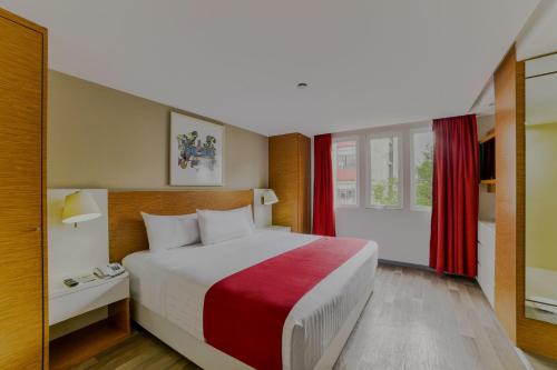 a hotel room with a large bed and a window at City Express by Marriott Ciudad de México Alameda in Mexico City