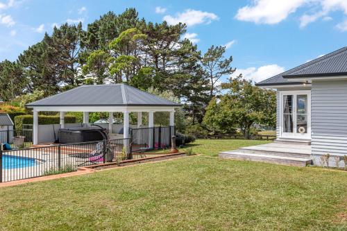 a gazebo with a pool in a yard at Countryside Haven Retreat with Pool and Deck in Clevedon