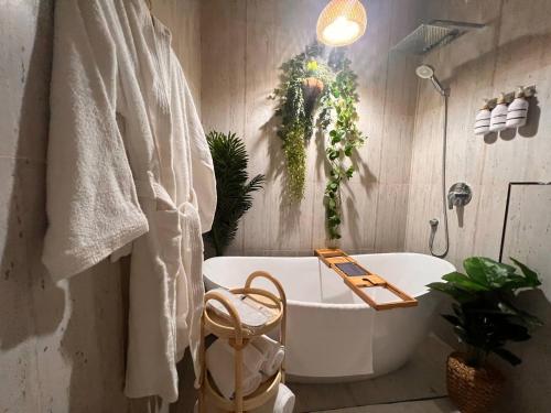 a bathroom with a white bath tub and a sink at Zaya luxury apartment in Riyadh