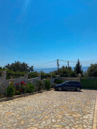 a car parked in a driveway in a yard at Dhori House Dhermi in Dhërmi