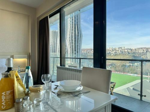 a dining room table with a view of a city at Full Comfort Apartment at Chavchavadze in Tbilisi City