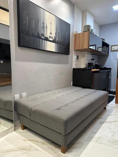 a bed in a room with a tv on a wall at Flat Jk 01 térreo in Juazeiro do Norte