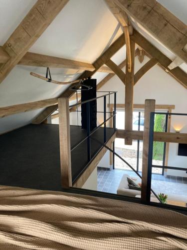 a room with a staircase and wooden beams at De Rheebok in Uddel