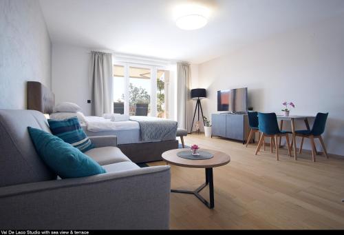 a living room with a couch and a bed and a table at Val De Laco studio apartments in Rovinj