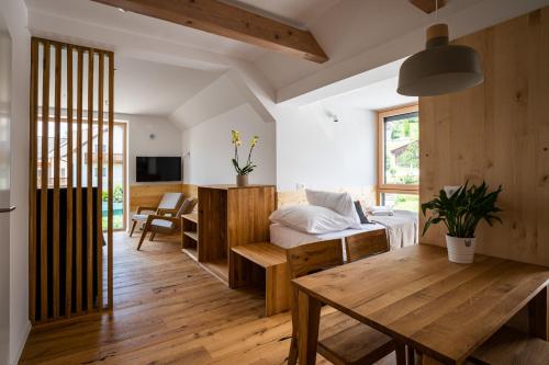 a living room with a bed and a table at LUCKA BLED quiet location, free bikes, big garden, doctor in Bled