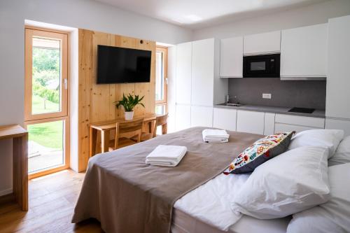 a bedroom with a large bed with two towels on it at LUCKA BLED quiet location, free bikes, big garden, doctor in Bled