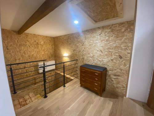a room with a cross on the wall and a dresser at Grange rénovée, 6 minutes du Lac d'Annecy vue sur le Mont-Blanc in Giez