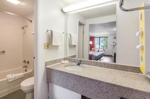 a bathroom with a sink and a toilet and a mirror at Motel 6-Salem, VA in Salem