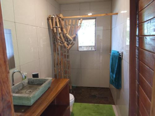 a bathroom with a sink and a toilet and a window at Infinity-house with roof terrace and direct access to the beach in Santana
