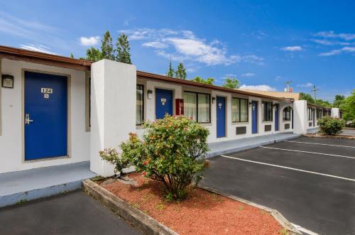 a row of buildings with blue doors in a parking lot at Motel 6-Salem, VA in Salem