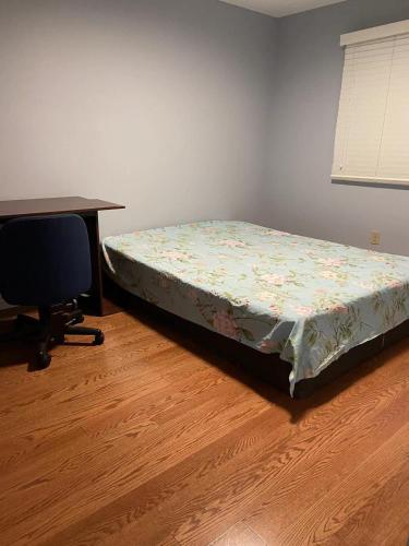 a bedroom with a bed and a desk and a chair at Aiyifan12138 in Waterloo
