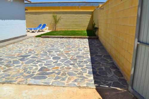 a patio with a stone floor next to a building at CHALET SOLYMAR in Conil de la Frontera