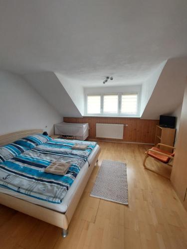 a bedroom with a large bed in a attic at Haus Jezek in Windischgarsten