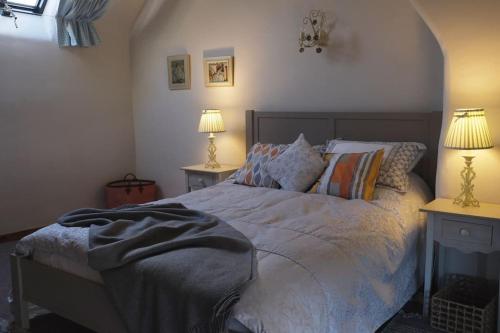 a bedroom with a bed with two lamps on two tables at Country Cottage near Yorkshire Coast in Bridlington