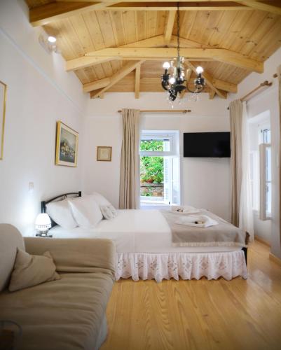 a bedroom with a large bed and a couch at Elena's Island House in Poros