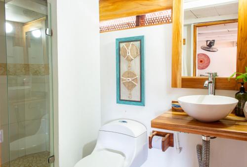 a bathroom with a sink and a shower at Hotel Isla del Sol in Isla Grande