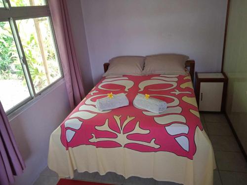 a bedroom with a bed with two towels on it at Chez Angele in Faie