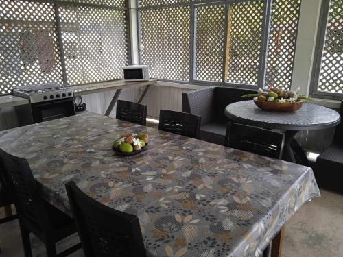 a dining room with a table with a bowl of fruit on it at Chez Angele in Faie