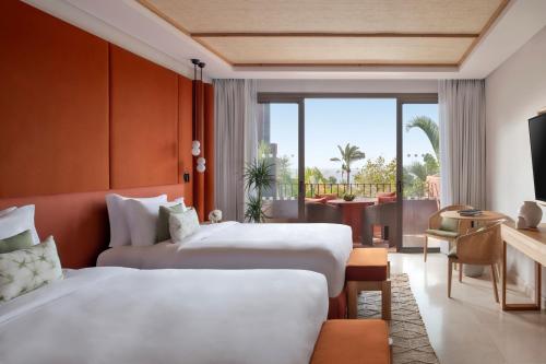 a hotel room with two beds and a balcony at The Ritz-Carlton Tenerife, Abama in Guía de Isora