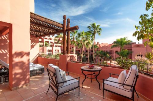 a patio with chairs and a table on a balcony at The Ritz-Carlton Tenerife, Abama in Guía de Isora