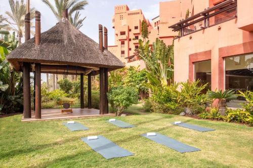 a garden with a gazebo and yoga mats at The Ritz-Carlton Tenerife, Abama in Guía de Isora
