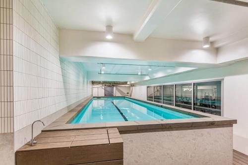 a swimming pool in a building at Brand New! Luxe 3BR In Aotea Square I Zodiak Stays in Auckland